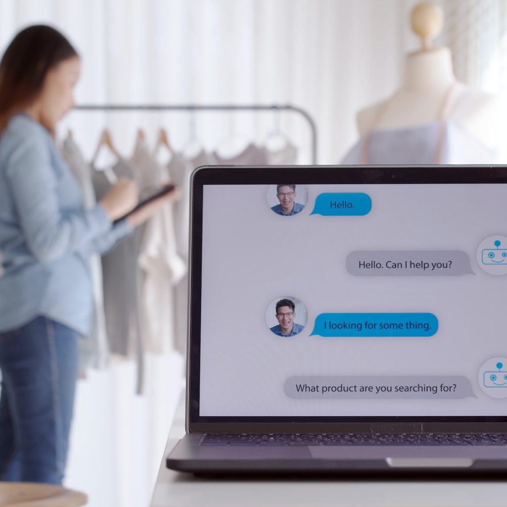 Chatbot conversation on laptop screen app interface with artificial intelligence technology