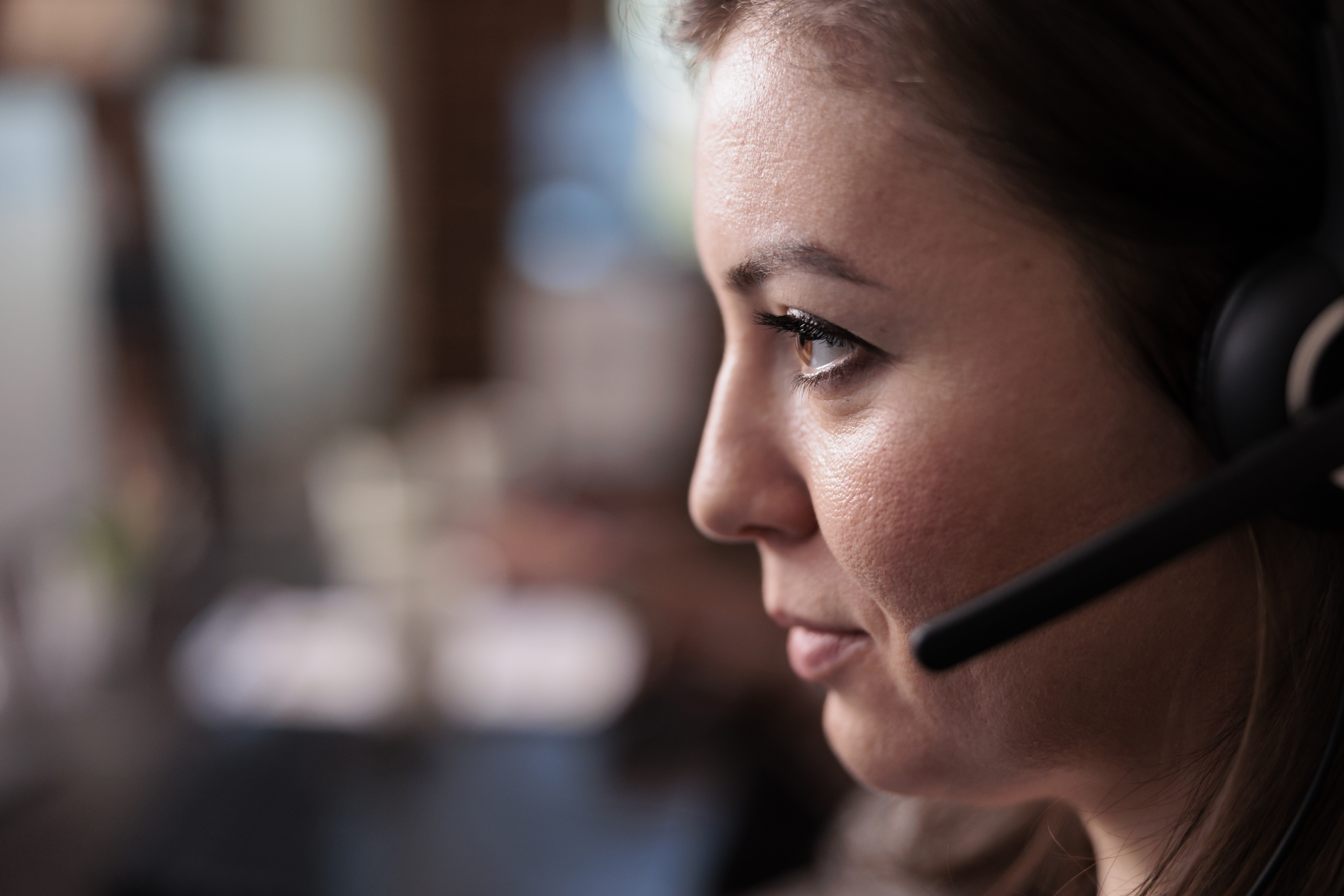 Telemarketing sales worker answering client call on headset