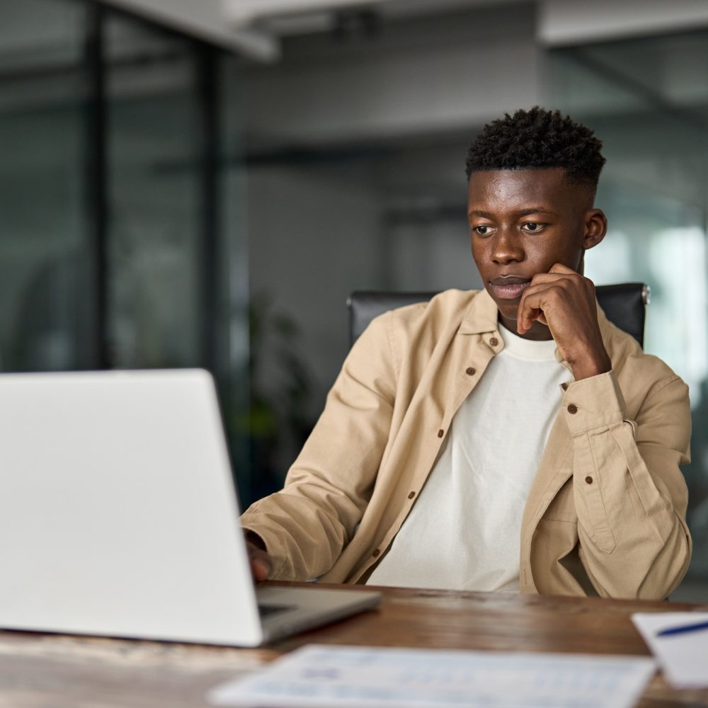 Busy African Black business man employee or student using laptop computer.